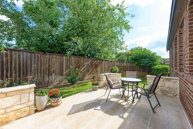 Fenced backyard with a patio and outdoor dining space | Image 17