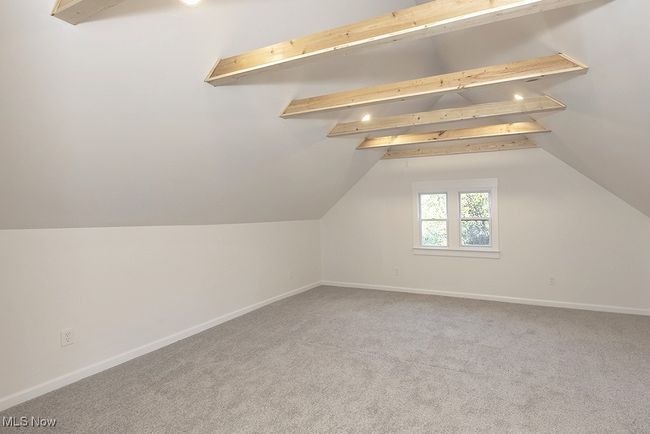 Bonus room featuring vaulted ceiling with beams and carpet flooring | Image 34