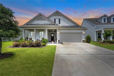 Welcome home to this two bedroom/two bathroom PLUS den Abbeyville home that is loaded with custom upgrades. The front of the home features a decorative stone accents, covered front porch and the driveway includes 2 foot extensions. | Image 1