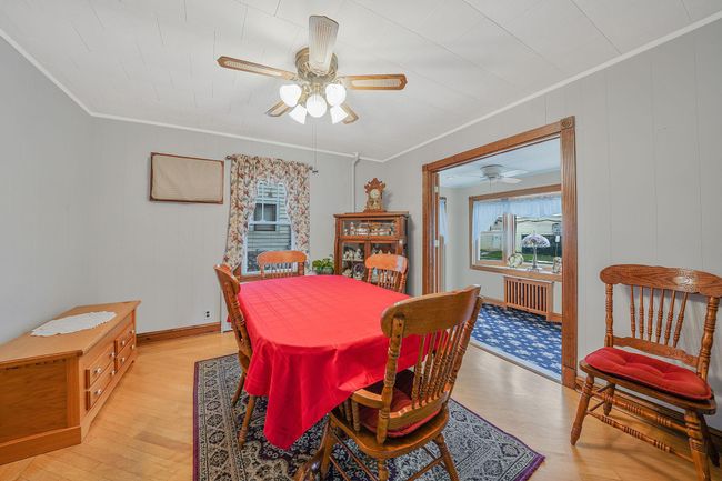 Dining room featuring radiator, crown molding, light wood-style flooring, and a ceiling fan | Image 9