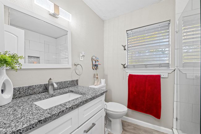 Full bathroom featuring toilet, wood finished floors, vanity, and walk in shower | Image 29