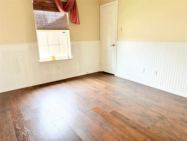 Unfurnished room with wainscoting and wood finished floors | Image 5