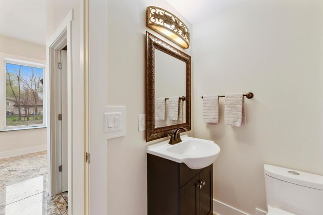 Main floor bathroom next to the walk-in coat closet | Image 18