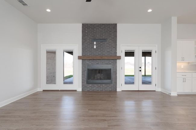 Unfurnished living room featuring french doors, visible vents, recessed lighting, and wood finished floors | Image 17
