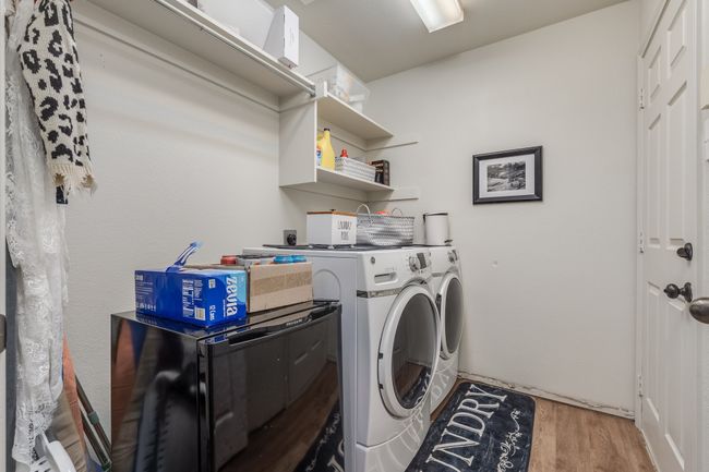 Laundry area with independent washer and dryer and wood finished floors | Image 32
