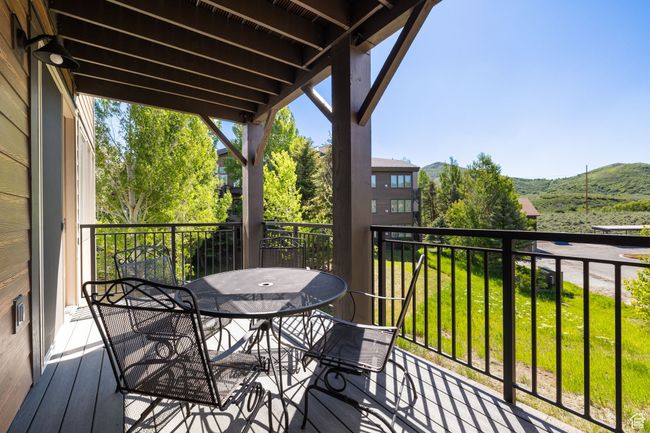 Balcony featuring outdoor dining area and a mountain view | Image 13