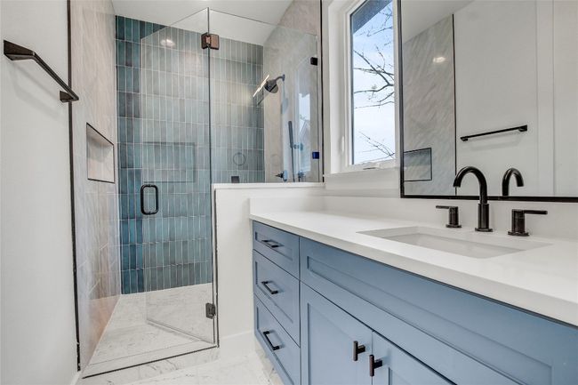 Full bath with vanity, a stall shower, and marble look tiles | Image 27