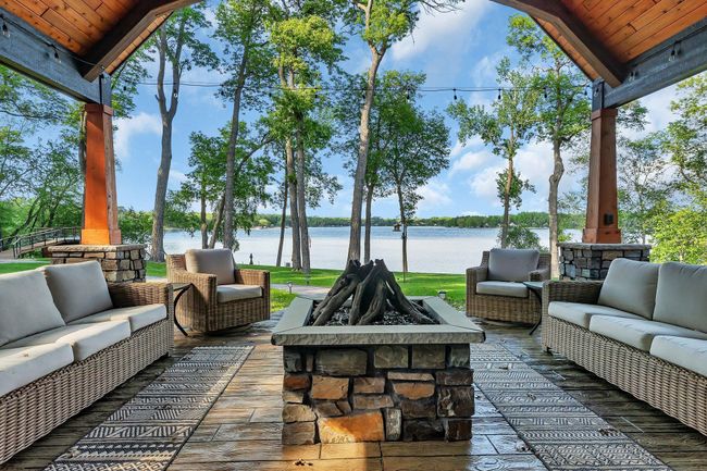 Stamped concrete patio with built-in gas firepit, vaulted cover, and stunning views of Big Fish Lake. | Image 8
