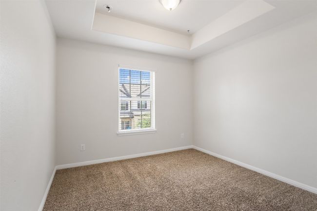 Carpeted spare room with a tray ceiling and a pendent fire sprinkler | Image 25