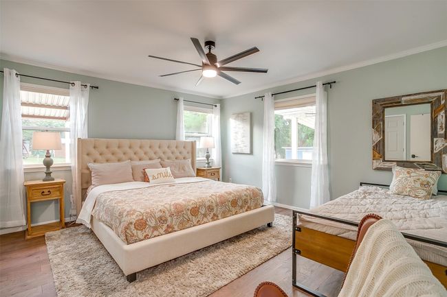 Bedroom featuring hardwood / wood-style floors, crown molding, baseboards, and a ceiling fan | Image 25