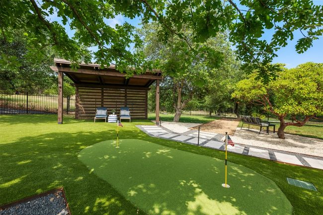 Putting area and cabana add to the fun outdoor living. Over 600 sf of turf grass installed. | Image 33
