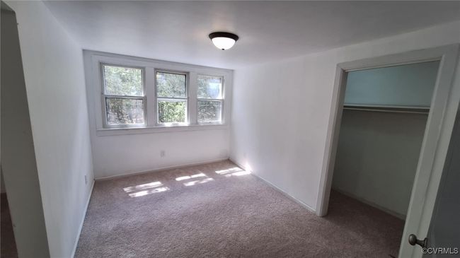 Unfurnished bedroom with carpet flooring and a closet | Image 32