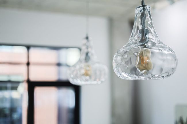 The pendant lighting above the kitchen island adds a focused glow, highlighting the workspace while complimenting the modern design of the room | Image 16
