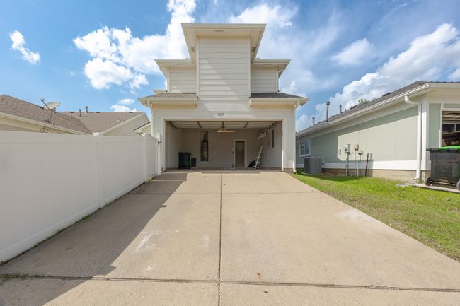Rear view of property featuring driveway and a garage | Image 37