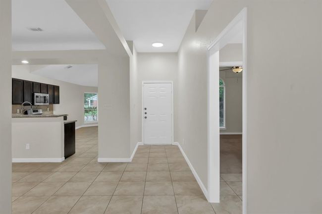 Looking from the back door to the front door. Two bedrooms and bath#2 through the doorway on the right. | Image 7
