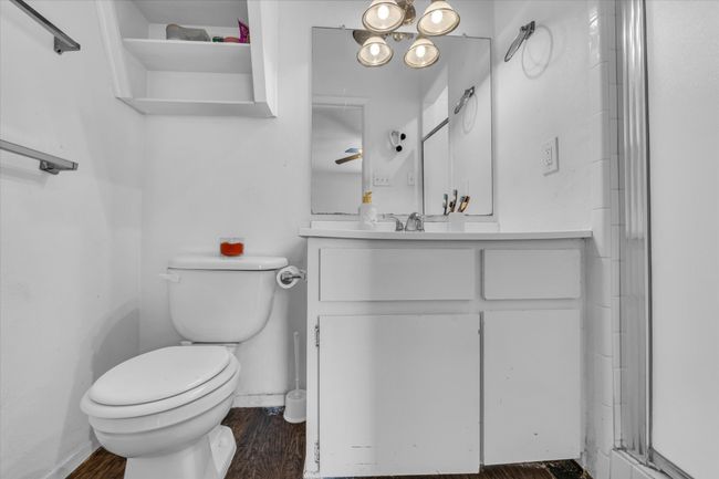 Bathroom with vanity, wood finished floors, and an enclosed shower | Image 12
