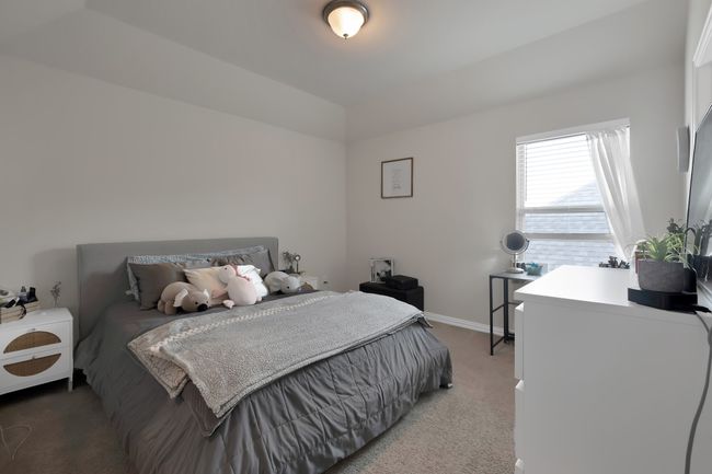 Bedroom with light carpet and baseboards | Image 33