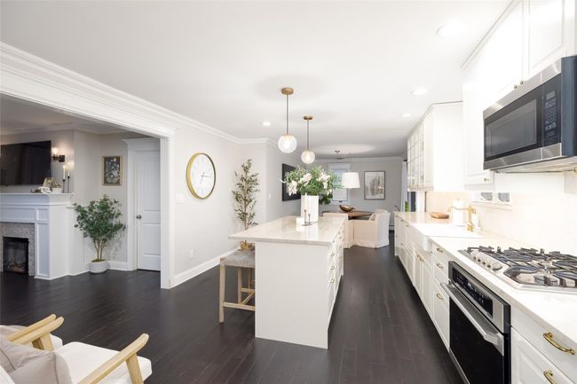 Kitchen with a breakfast bar, baseboards, stainless steel appliances, and recessed lighting | Image 21