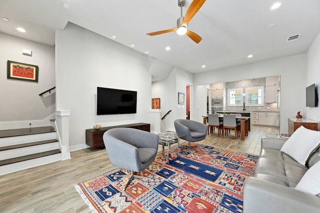 Living room on the main floor. Open to all areas of the main floor. Opens directly to a balcony. | Image 14