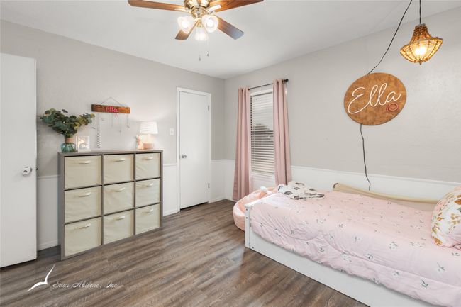 Bedroom with baseboards and wood finished floors | Image 22