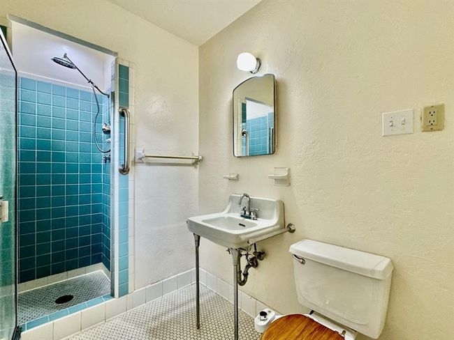 Bathroom featuring a tile shower and tile patterned floors | Image 16