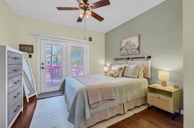 Bedroom with access to exterior, wood finished floors, ceiling fan, and baseboards | Image 17