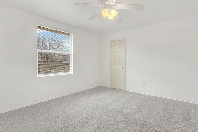 Empty room featuring carpet floors, baseboards, and a ceiling fan | Image 32