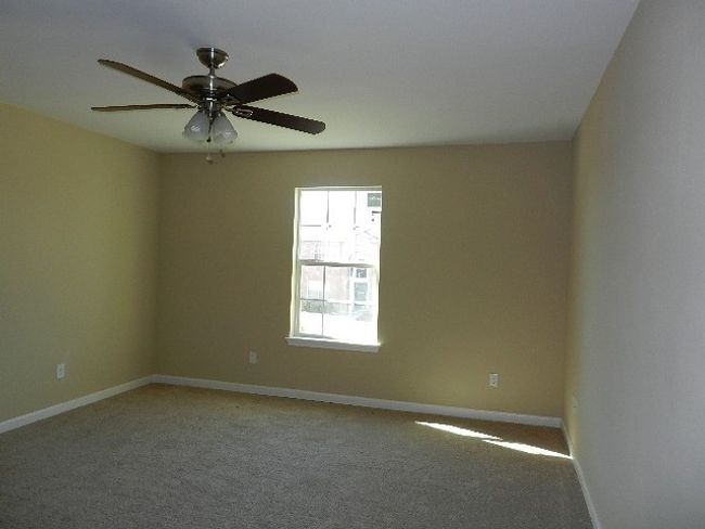 Empty room featuring light carpet and a ceiling fan | Image 16