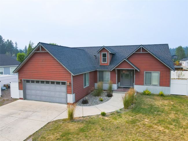 View of front of property with roof with shingles, a front yard, fence, an attached garage, and driveway | Image 11