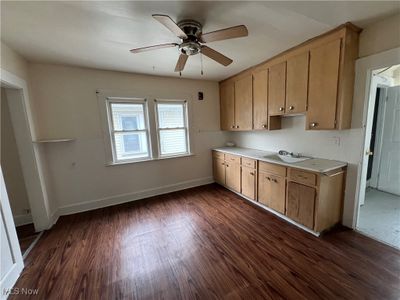 Kitchen with ceiling fan, dark wood-type flooring, and sink | Image 3