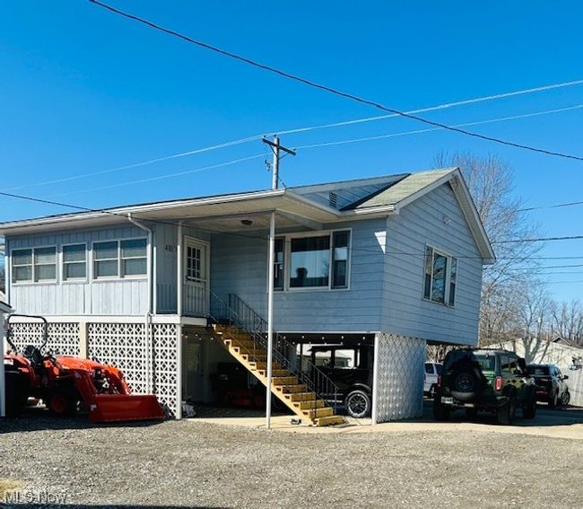 View of rental house with a carport and stairway | Image 24