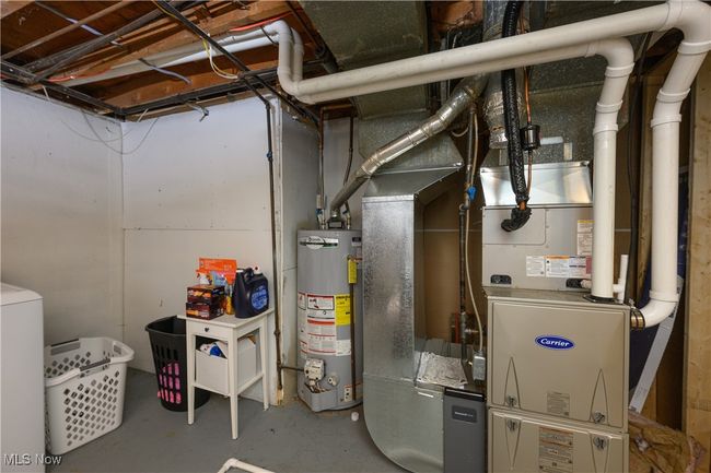 Utilities featuring water heater and washer / clothes dryer | Image 19