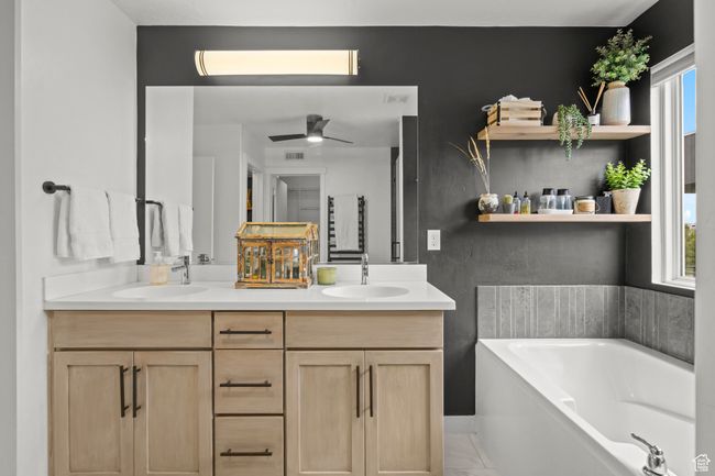Full bathroom featuring double vanity, a garden tub, and ceiling fan | Image 20