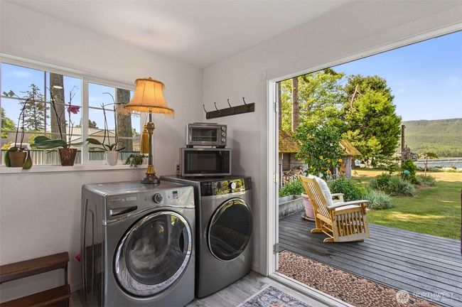Laundry room with french doors to enjoy the beauty of backyard while doing chores. | Image 25