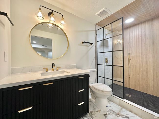 Full bath featuring marble finish floors, vanity, and a shower stall | Image 34
