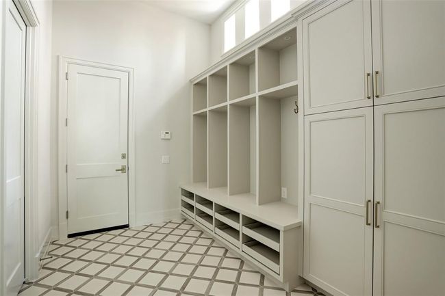 Designed for everyday ease, the mudroom offers generous storage and seamless access to the expansive three-car garage, making organization effortless. | Image 33