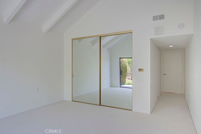 Primary bedroom closet has sliding mirrored doors. | Image 20