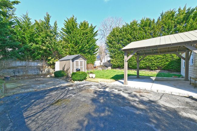 View of yard with a gazebo, fence, an outdoor structure, a storage shed, and a patio | Image 17