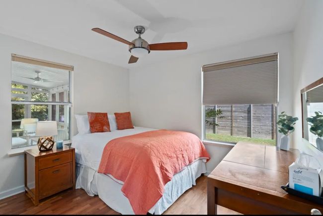 Bedroom with wood finished floors and a ceiling fan | Image 17