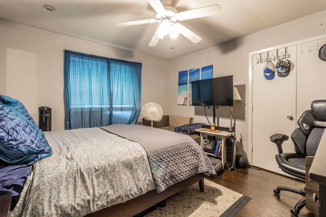 Bedroom with wood finished floors and a ceiling fan | Image 18
