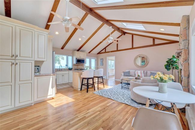 Living room featuring a skylight, a ceiling fan, light wood-style floors, and recessed lighting | Image 10