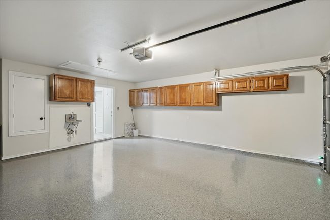 Garage with a garage door opener and baseboards | Image 37