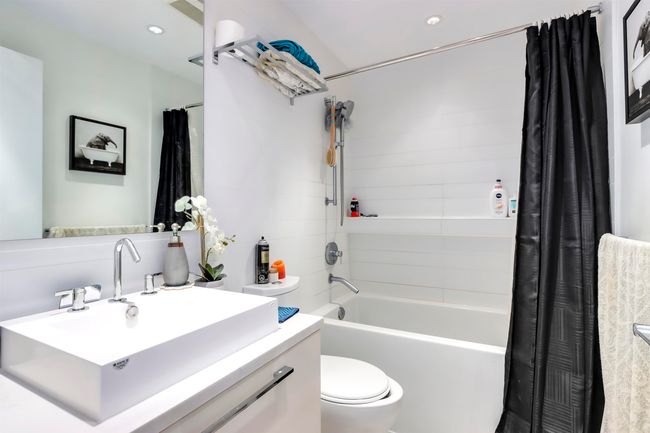 Bathroom with vanity, shower / tub combo, toilet, and recessed lighting | Image 13