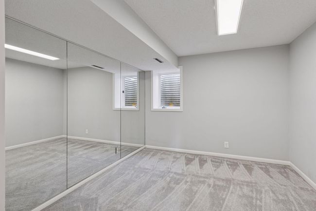 Lower level bedroom with egress window, new carpet and paint | Image 16