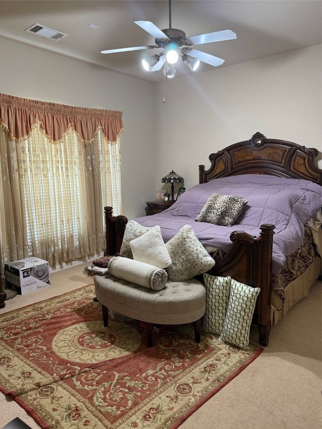 Carpeted bedroom featuring a ceiling fan | Image 21