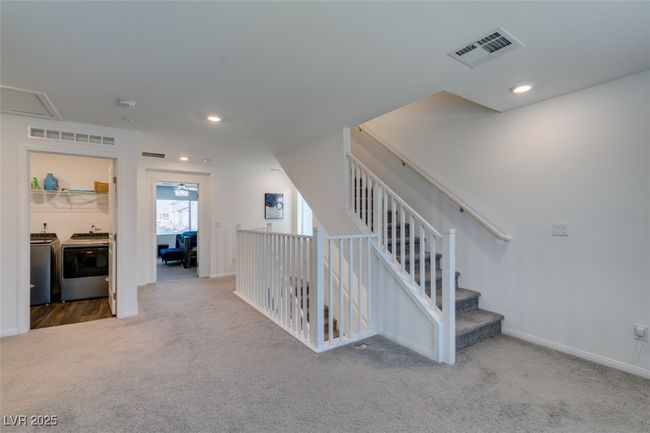 Stairway with carpet flooring, separate washer and dryer, baseboards, visible vents, and recessed lighting | Image 19