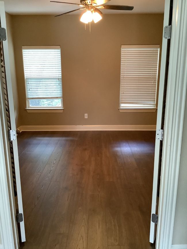 Unfurnished room featuring ceiling fan and dark wood-type flooring | Image 4