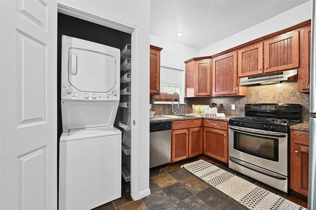 A convenient laundry closet with stack washer and dryer convey with the home. | Image 11