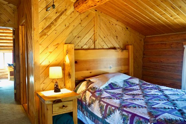Bedroom with rustic walls, carpet flooring, wooden walls, and wooden ceiling | Image 40