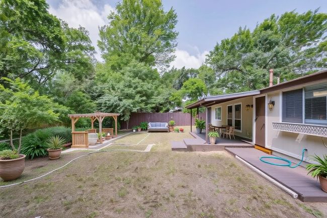 View of yard featuring an outdoor living space, a patio area, and a pergola | Image 33